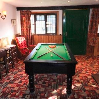 pub with green wooden door ceiling spotlights and pool board