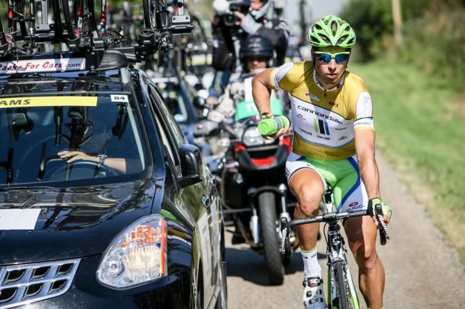 Peter Sagan (Cannondale) goes to the team car to load up with water bottles.