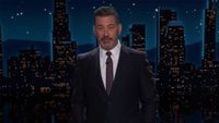 Jimmy Kimmel Live screenshot of Jimmy Kimmel in a suit and tie with a NYC backdrop. 