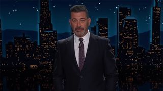 Jimmy Kimmel Live screenshot of Jimmy Kimmel in a suit and tie with a NYC backdrop. 