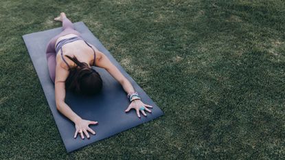 Woman doing a hip stretch outdoors