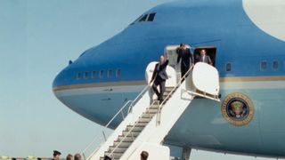 George H.W. Bush waves as he boards the Air Force One to take the maiden voyage on the converted jumbo Boeing 747.