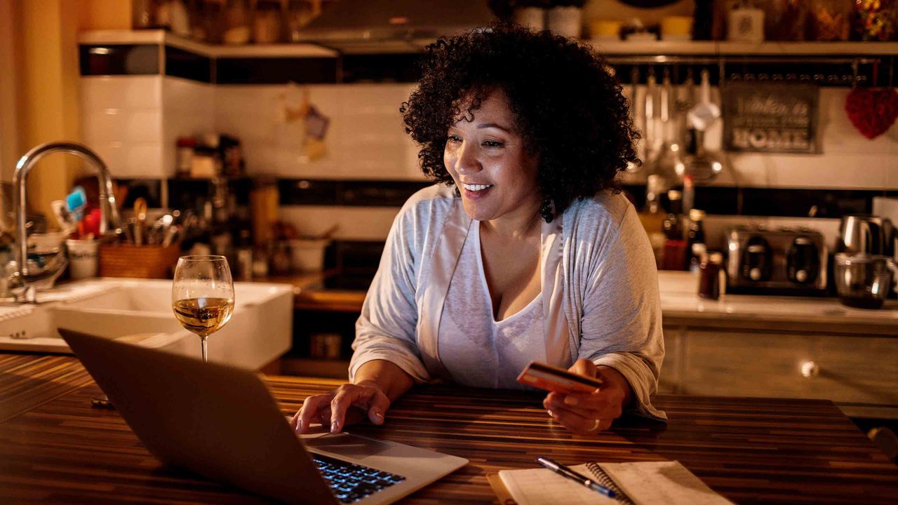 Close up of a mature woman using her laptop and online shopping