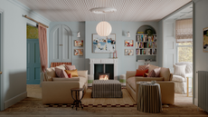 a large living room with two tan couches facing each other, striped pillows, a striped ottoman, a striped side table, and a striped accent chair in the window. The ceiling features striped wood beams as well. The blue-painted walls are decorated with artwork and right of the fireplace is a bookshelf
