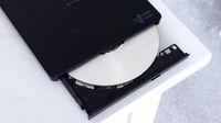 A photo of an LG-Hitachi Blu-ray drive open with a blank disc in the tray