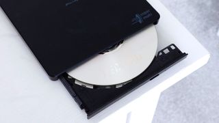 A photo of an LG-Hitachi Blu-ray drive open with a blank disc in the tray