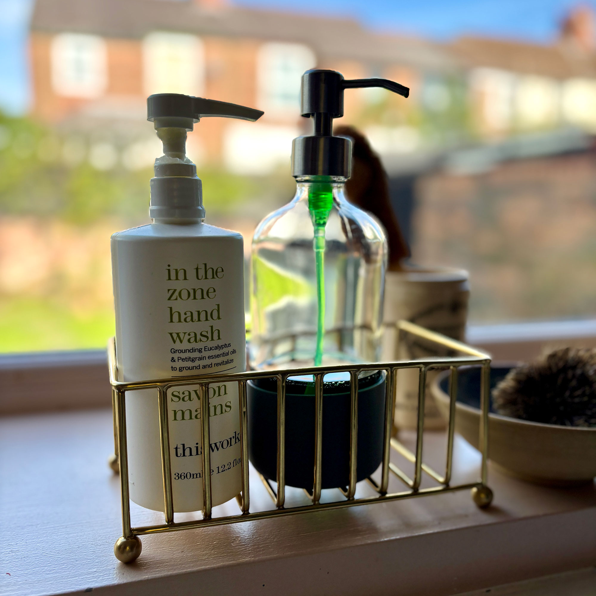 Metal sink caddy with handwash bottles