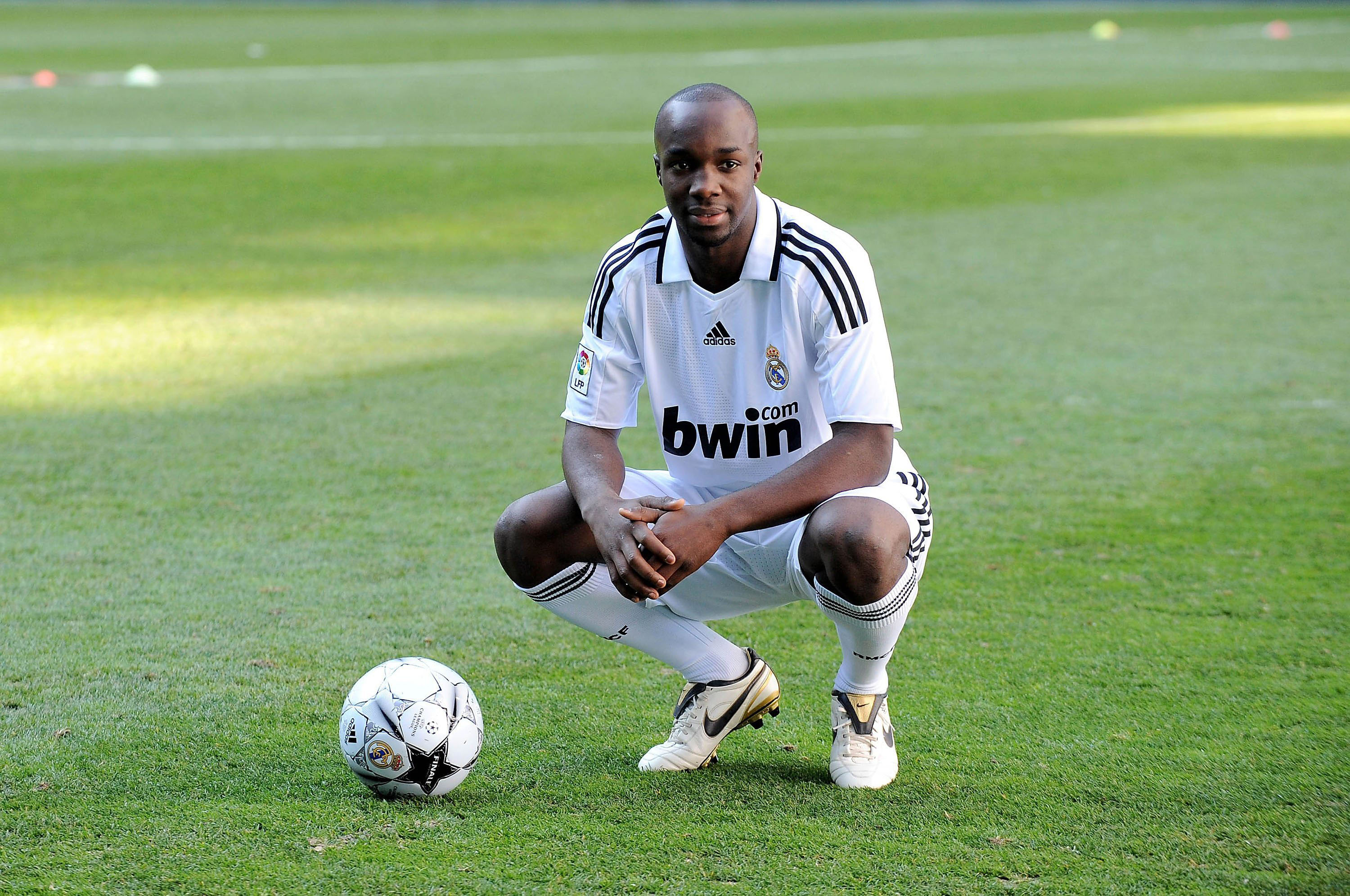 Lassana Diarra poses while at Real Madrid with a ball on the Santiago Bernabeu pitch