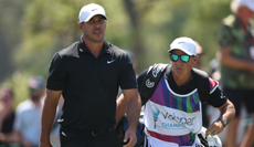 Brooks Koepka and his caddie walk down the fairway