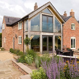 Double storey rear glass extension on brick house