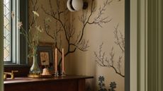 a room with a golden wallpaper with trees on