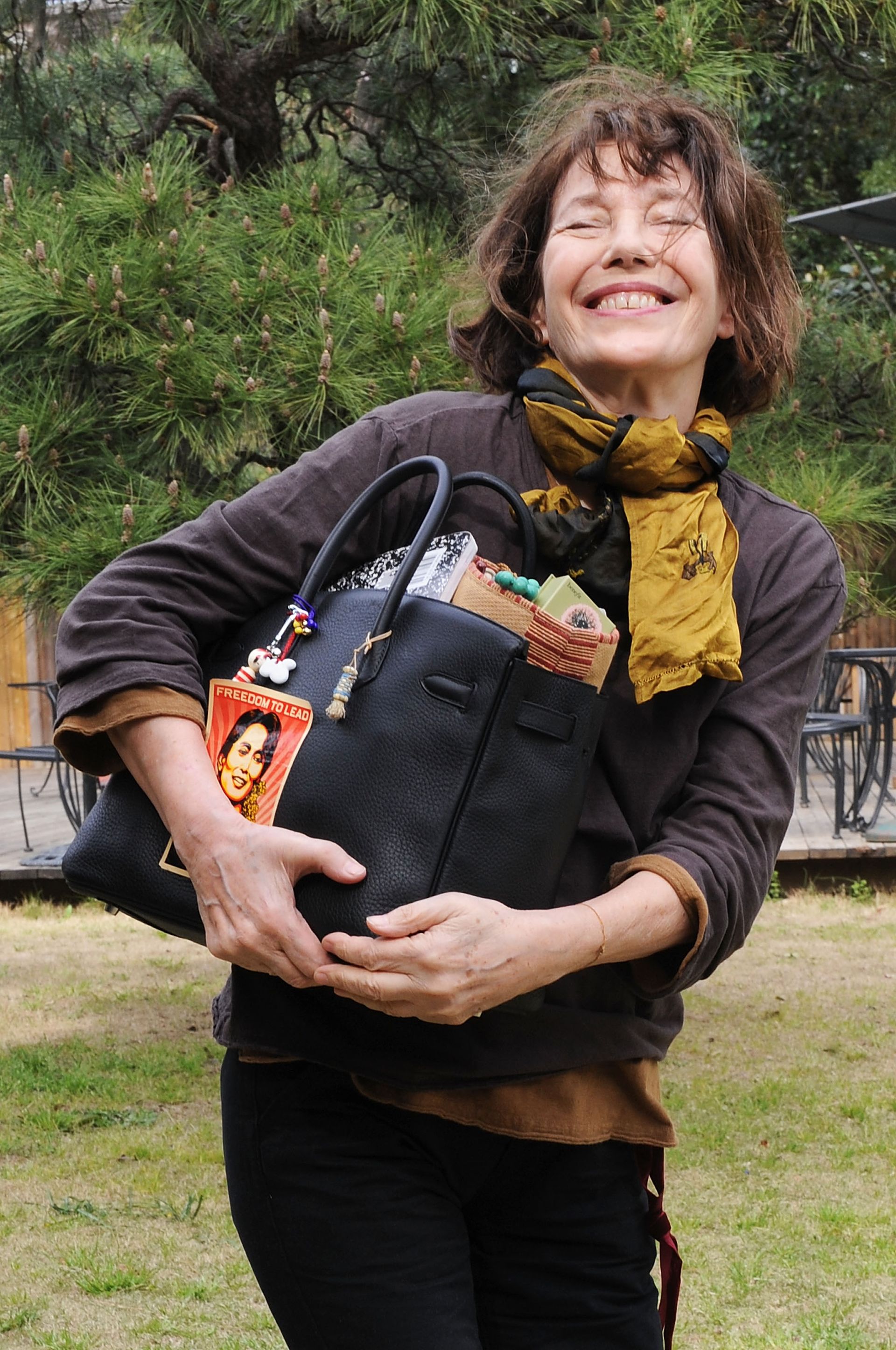 Jane Birking wears a black Hermes bag with bag charms.