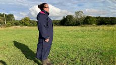 Lady wears Rydale Utility Changing Robe in a field, viewed from the side