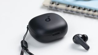 Anker Soundcore P20i earbuds next to charging case