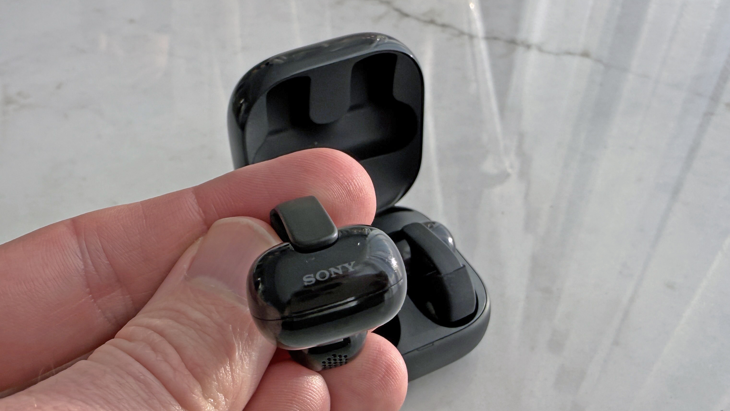 Sony LinkBuds Clip in man's hand, showing the Sony logo