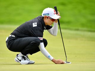 Hyo-Joo Kim reading a putt on the green