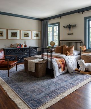 neutral kids bedroom with painted trims and a vintage rug