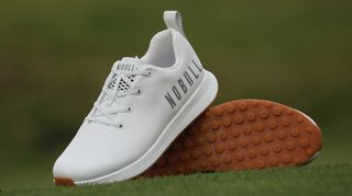 Nobull Leather Golf Shoe resting on the golf course showing off their cool leather upper and brown sole