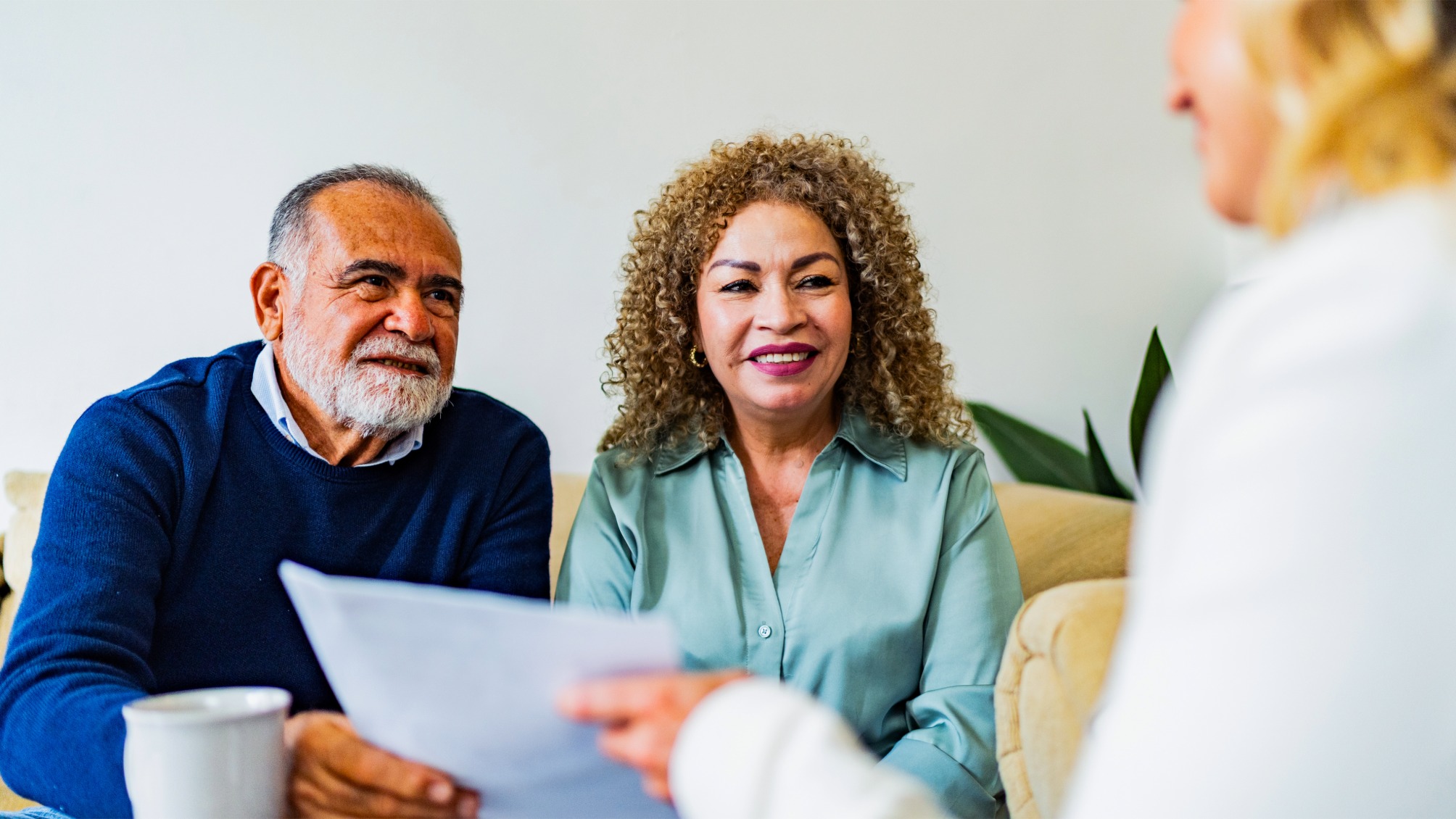 Senior couple talking to financial advisor at home