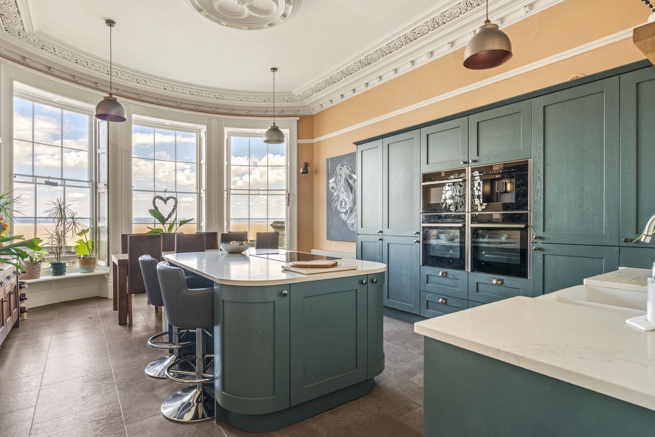 Detail of the interiors of Woodside, featuring lots of soft blues, funky artwork, wooden floors, and natural light