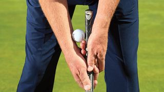 Using a golf ball on the grip to help with the putting stroke