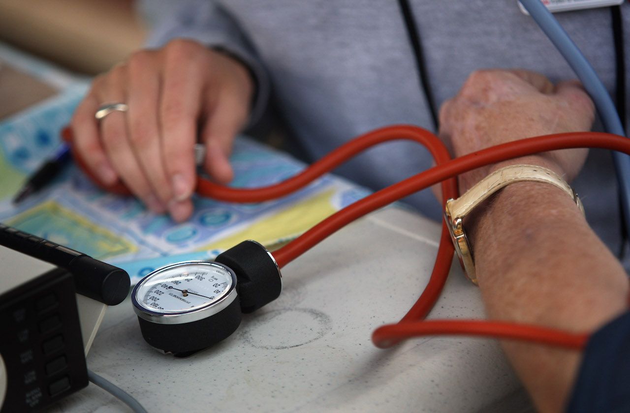 WISE, VA - JULY 25:A nurse checks a patient&amp;#039;s blood pressure at the Remote Area Medical (RAM), healthcare clinic July 25, 2008 in Wise, Virginia. The free weekend clinic, staffed by more than