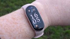 One of the watch face choices on the Xiaomi Smart Band 10, showing a floral design in dark colors. 