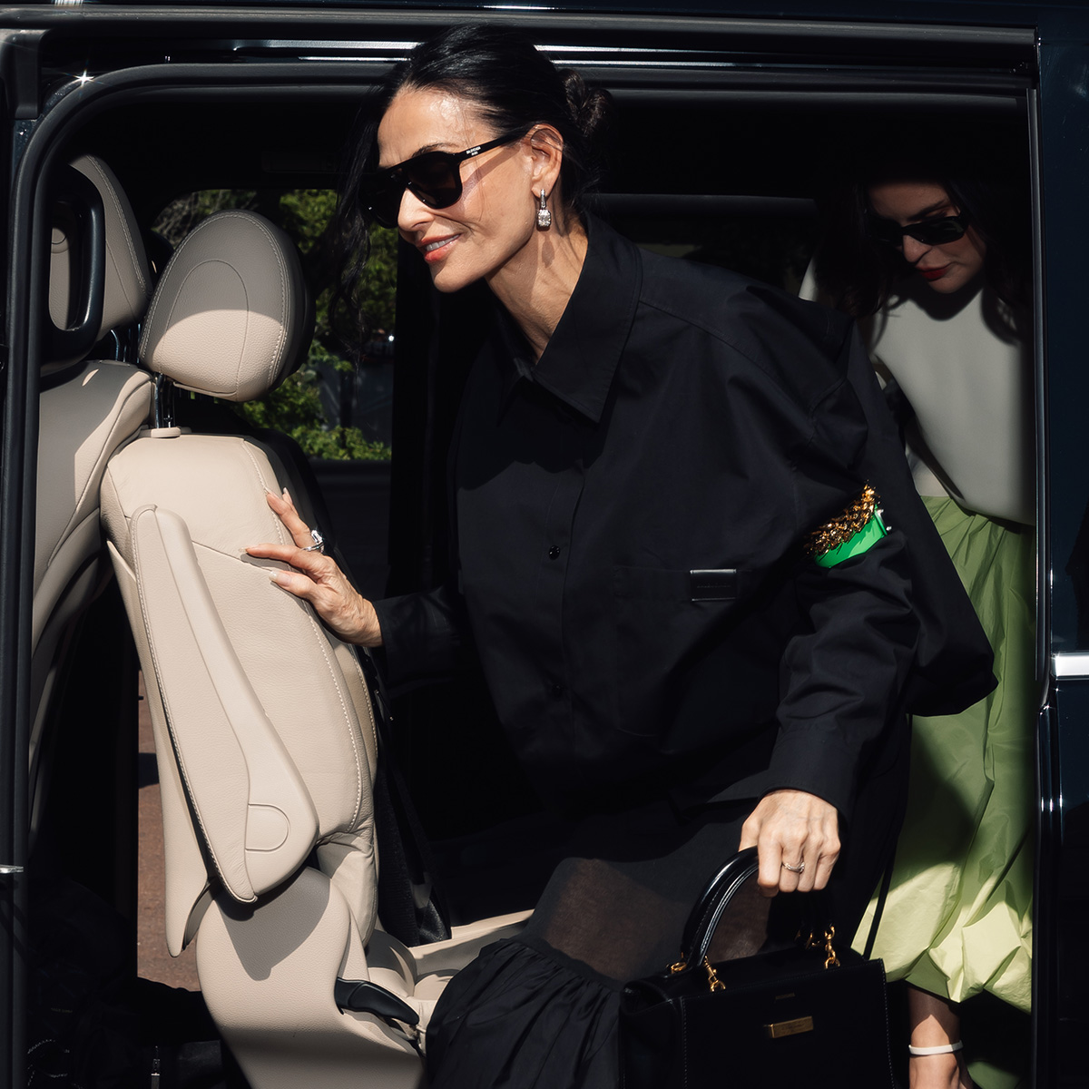 demi moore wears a balenciaga hourglass avenue bag.