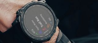 Man's wrist wearing Garmin Tactix 7 watch