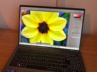 Acer Swift X laptop open with bright yellow flower on screen
