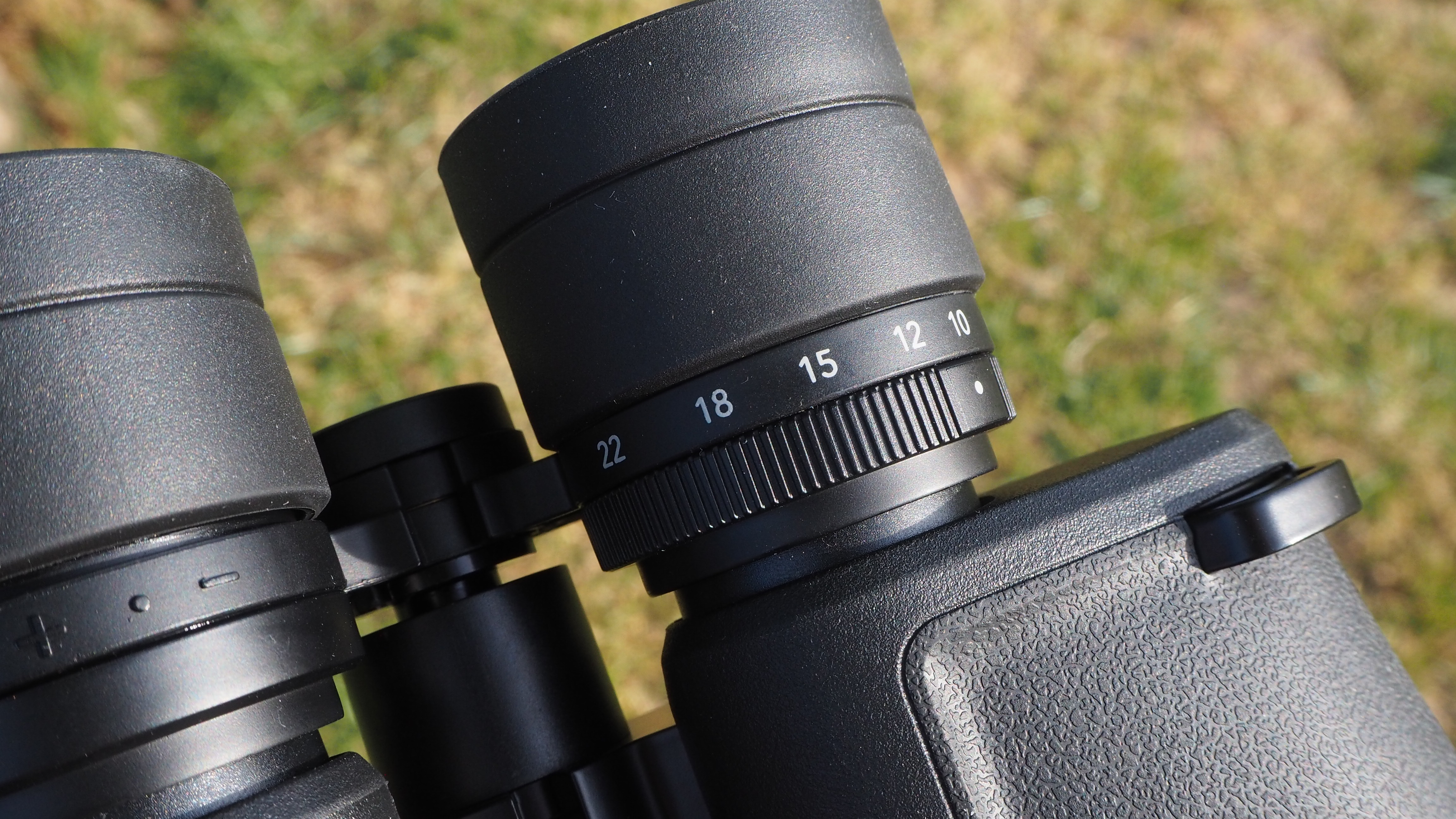 Close-up of Nikon Action Zoom 10-22x50 binoculars zoom mechanism