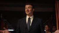 a slick male politician in a 3-piece suit