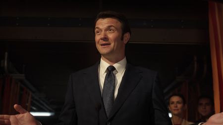  a slick male politician in a 3-piece suit