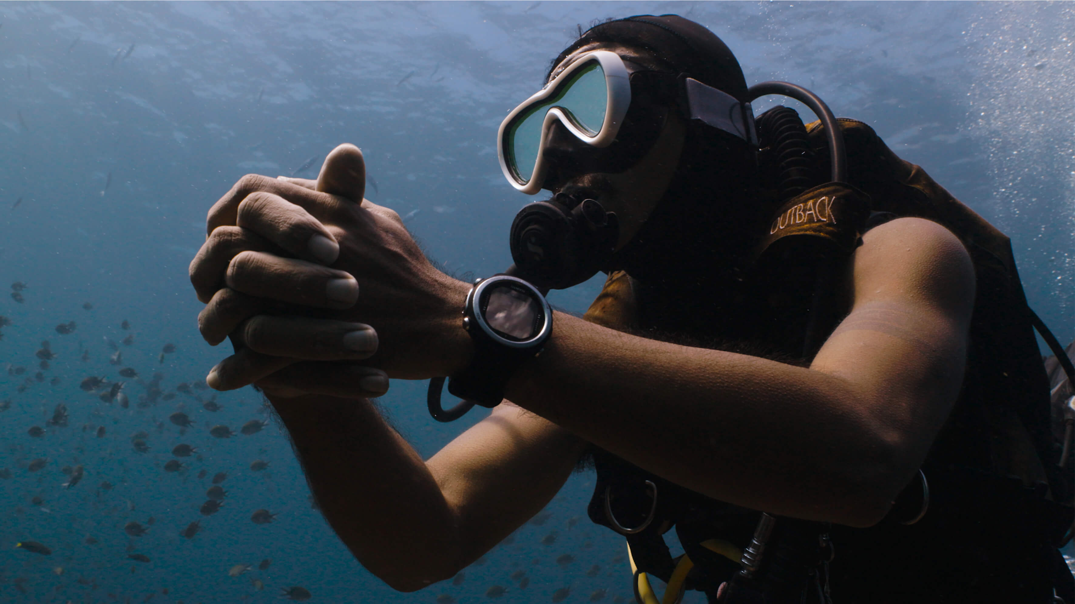 Diver clasping hands.