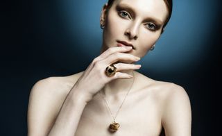 woman wearing gold jewellery by Ramona Albert