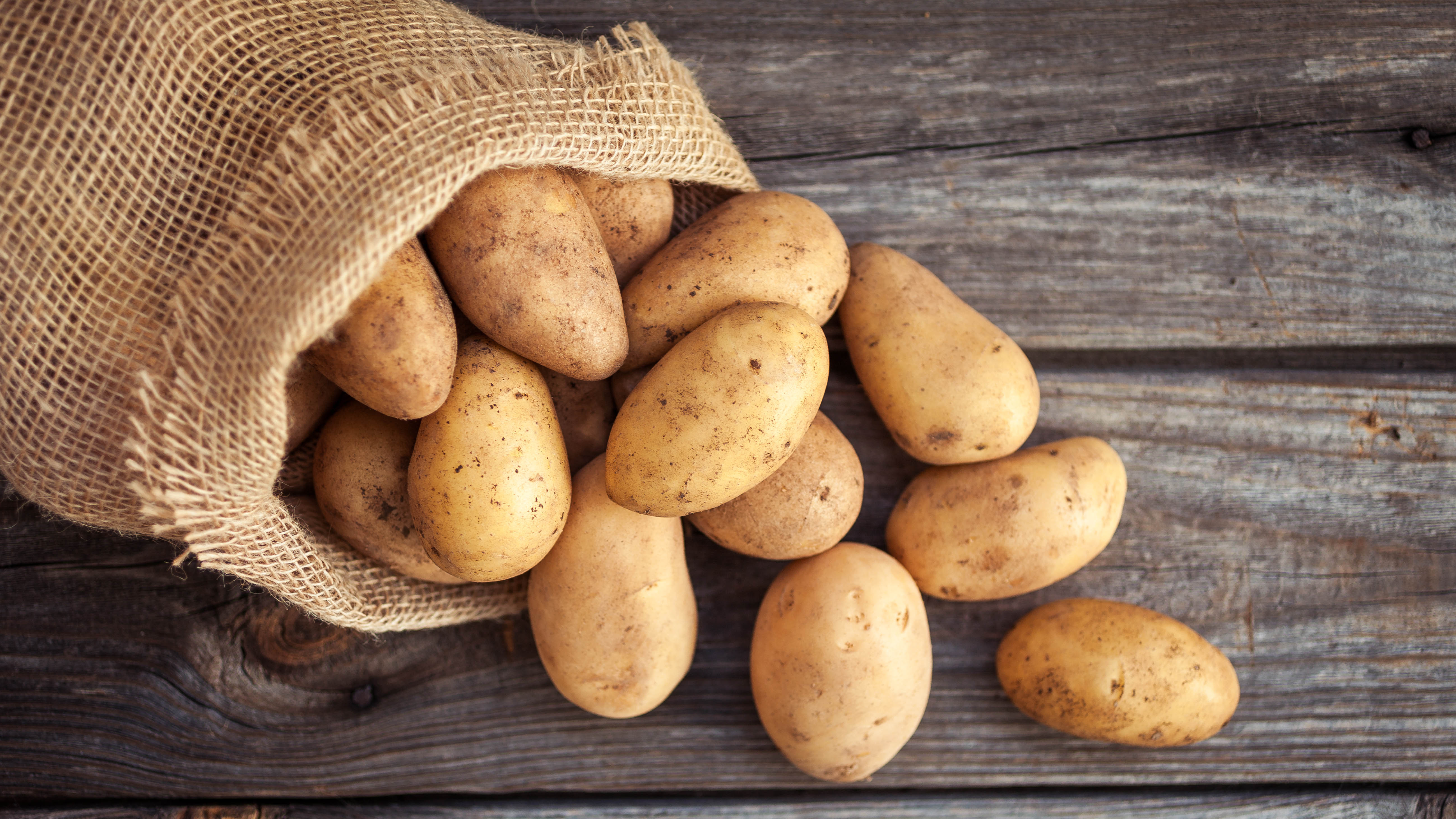 A bag of potatoes on a wooden surface