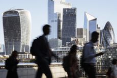UK, London, blurred motion of incidental business people walking to work with view of the financial district behind gilts