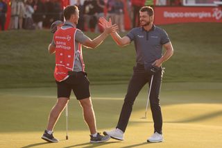 Laurie Canter shakes hands with his caddie