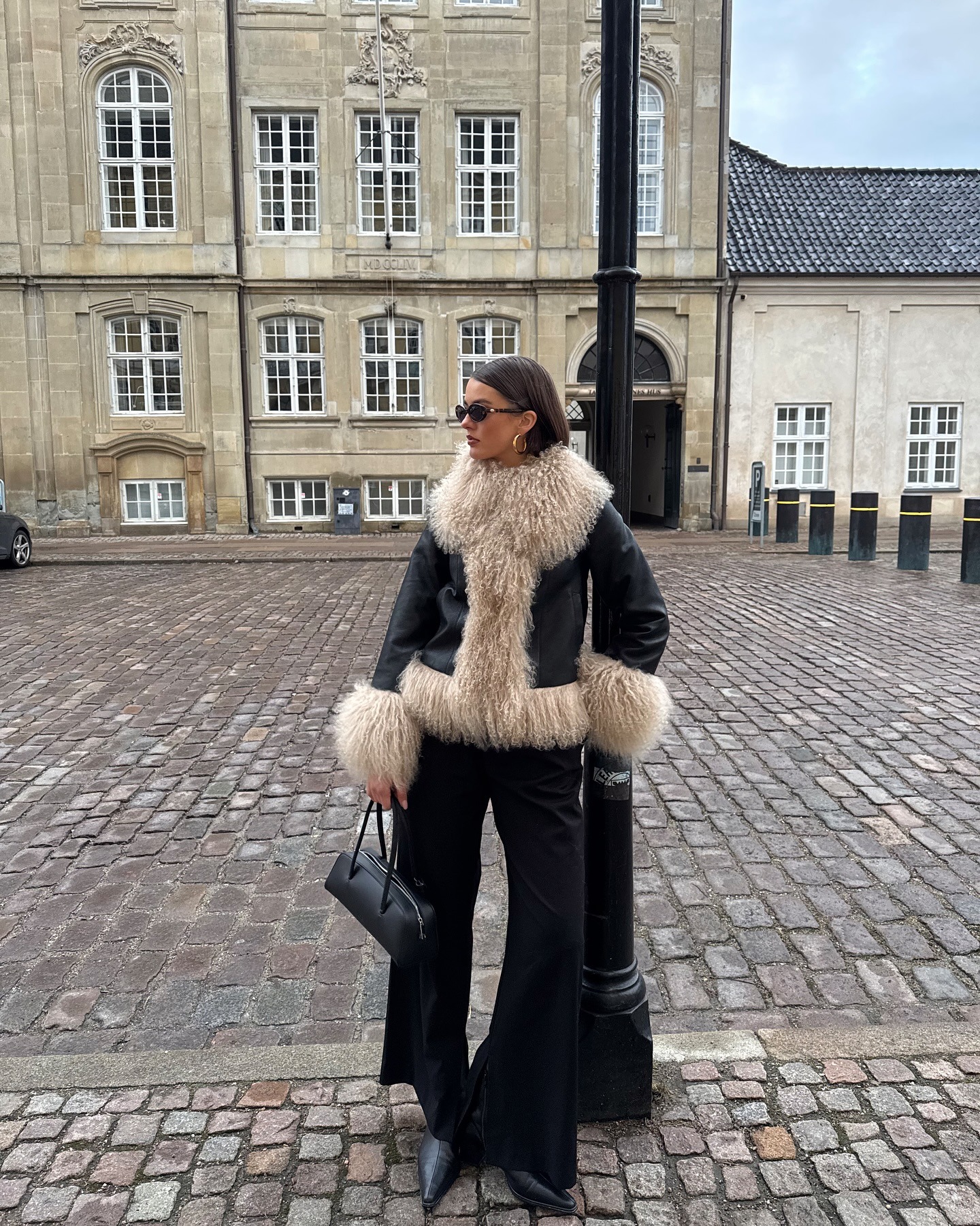 A woman in a furry leather jacket.