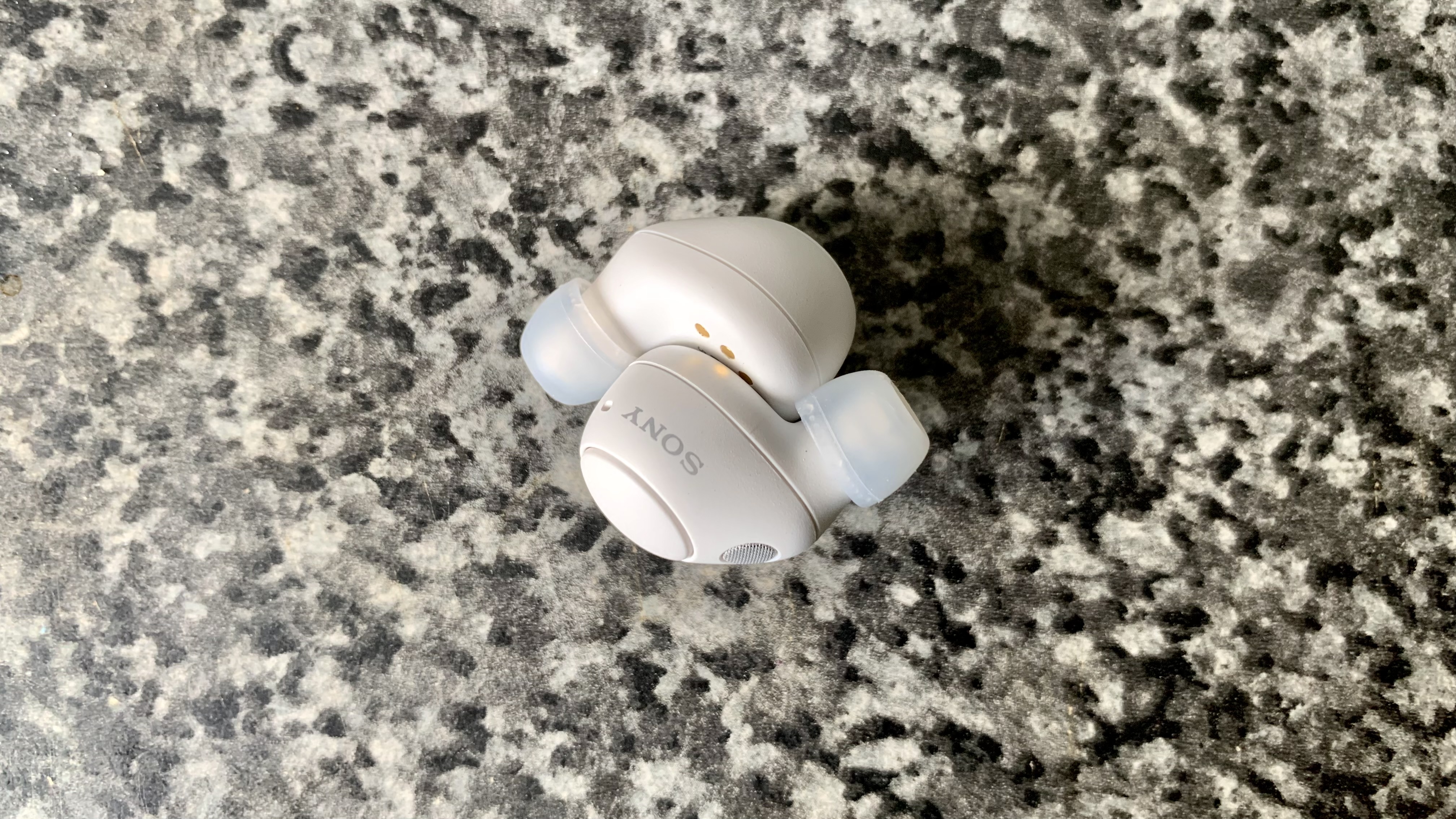 Sony WF-C700N earbuds on gray background