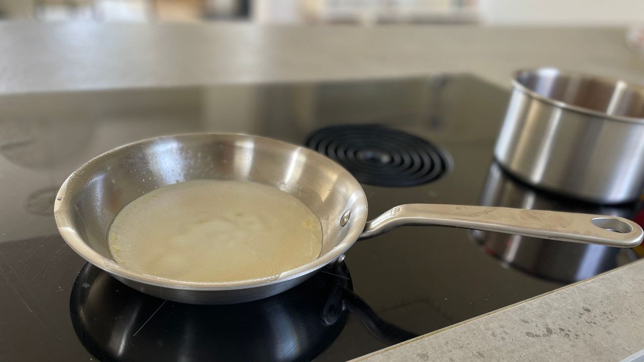 A pancake being cooked in the Made In 10-piece Stainless Steel Pan Set frying pan on an induction hob