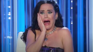 Katy Perry holds her hand to her cheek and screams while judging on American Idol