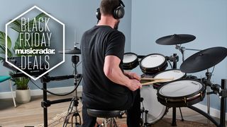 Man playing Alesis Strata Prime electronic drum set