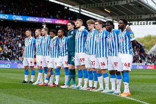 Huddersfield Town players gather to observe the national anthem before the Sky Bet Championship between Huddersfield Town and Reading at John Smith's Stadium on May 08, 2023 in Huddersfield, England. 