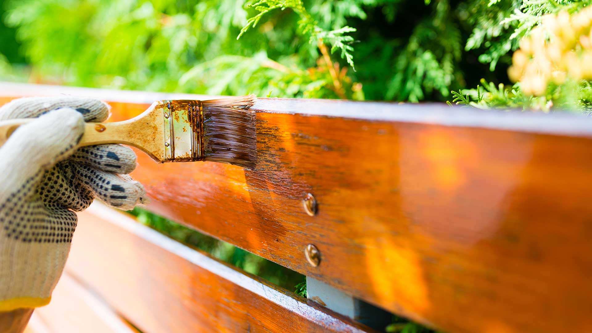 painting a wooden fence close-up