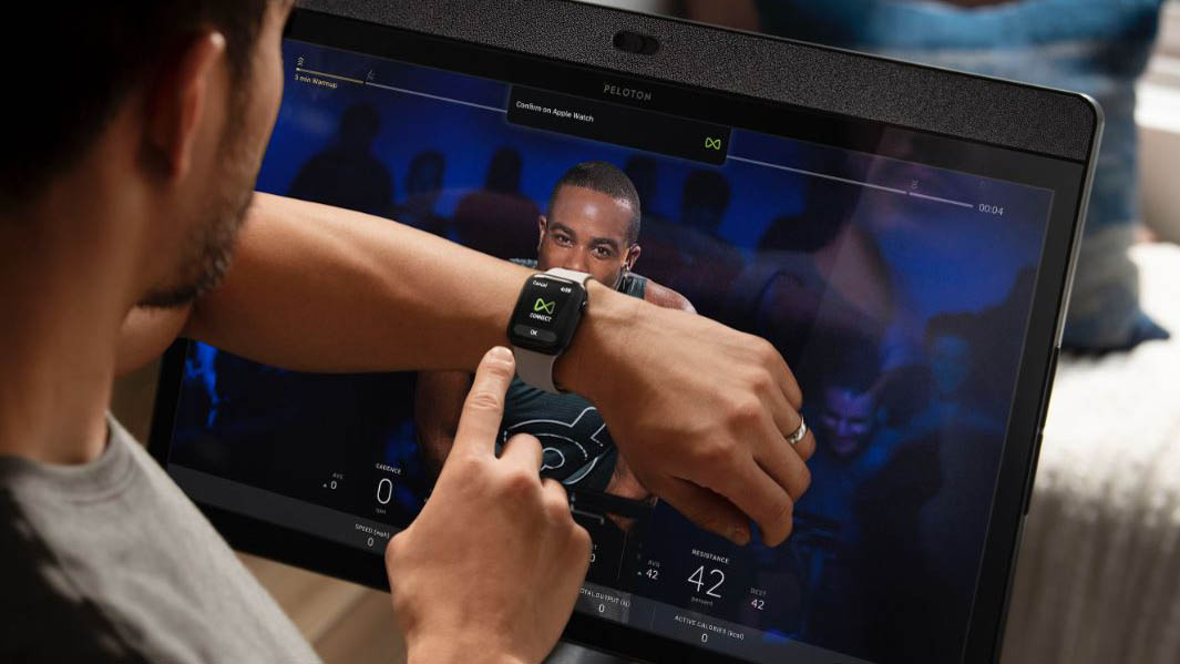 Someone pairing an Apple Watch with a class on Peloton