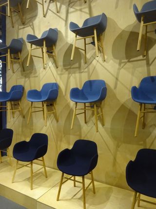 Blue chairs with wooden frames hanging on the wall