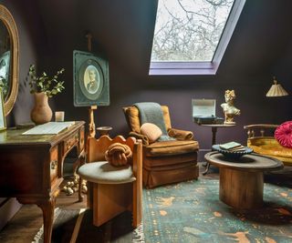 bedroom with dark walls and vintage furniture with rooflight