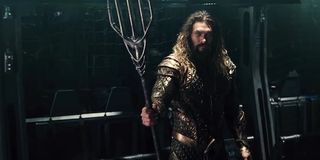 Jason Momoa as Aquaman holding trident