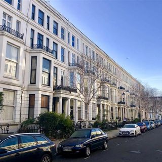 exterior of a flat with lots of cars parked